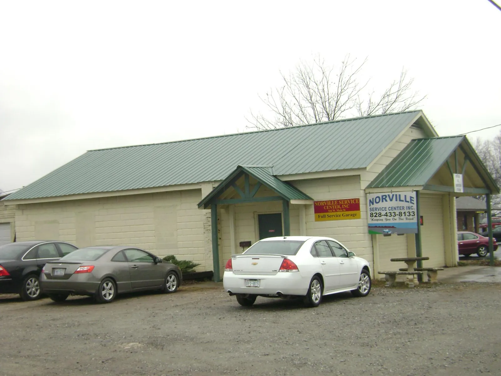 Green metal roof on a service garage with a covered entry in Winston-Salem